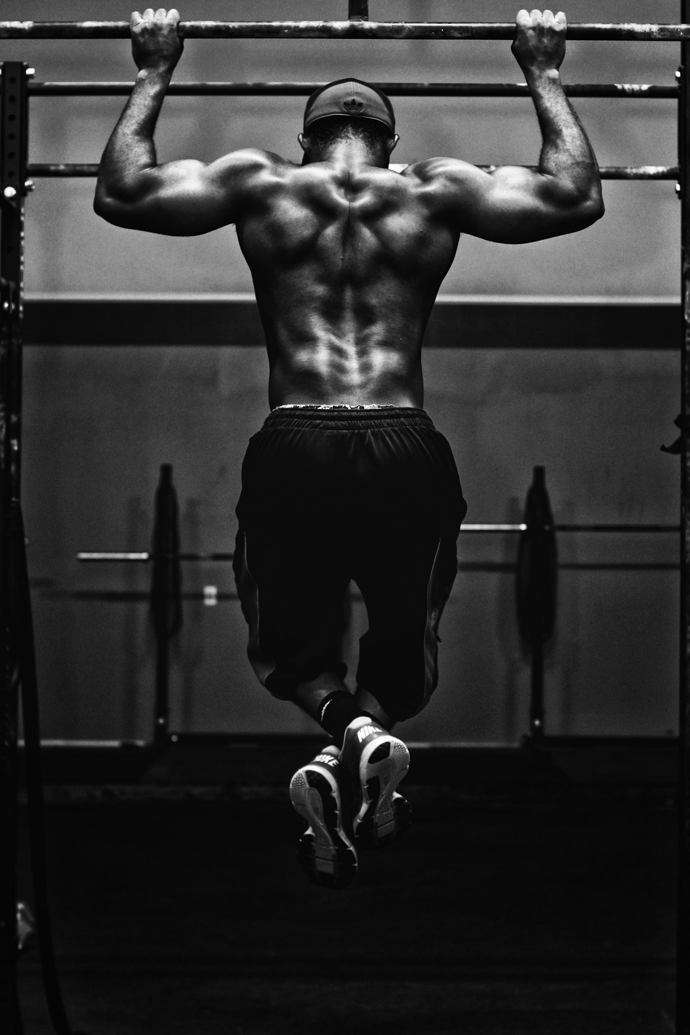 A person performing a pull-up on a bar